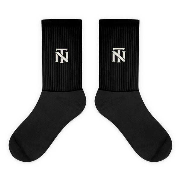 Black NERVE & Thread Signature line crew socks with the ivory Woven NT monogram printed at the calf.