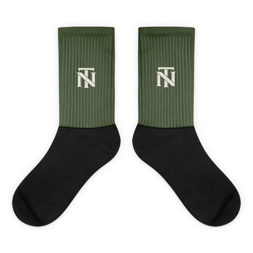 Olive NERVE & Thread Signature line crew socks with the ivory Woven NT monogram printed at the calf.