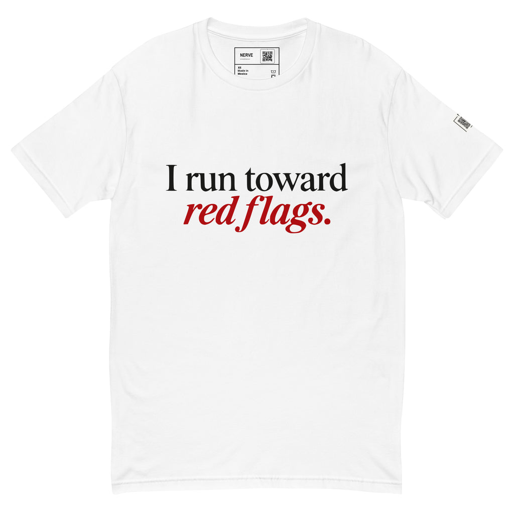 White short-sleeve tee with “I run toward red flags.” lettering, with “red flags.” printed in red.