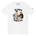 White short-sleeve tee with “It says fold it in!” lettering, a man stirring a pot and a woman holding a card and bowl.