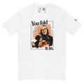 White short-sleeve tee with “You fold it in.” lettering and a woman in glasses holding a card.