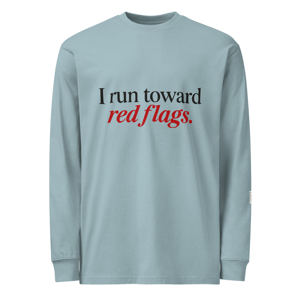 Agave long-sleeve tee with “I run toward red flags.” lettering; “red flags” is printed in red.