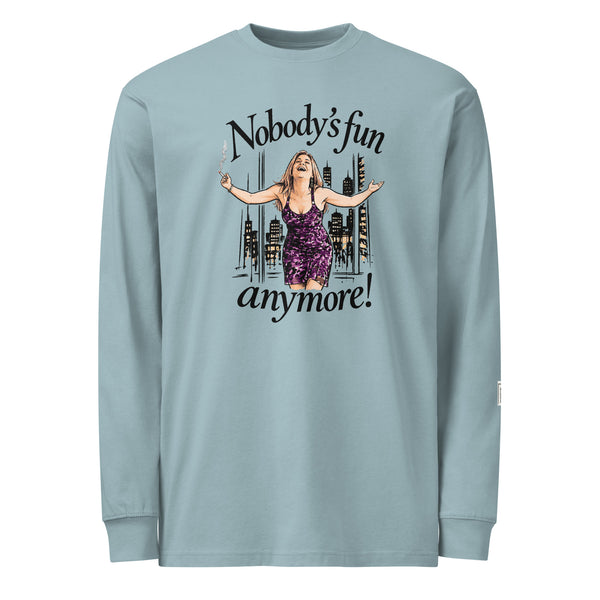 Agave long-sleeve tee with “Nobody’s fun anymore!” lettering and a woman in a purple dress with outstretched arms against a city skyline.